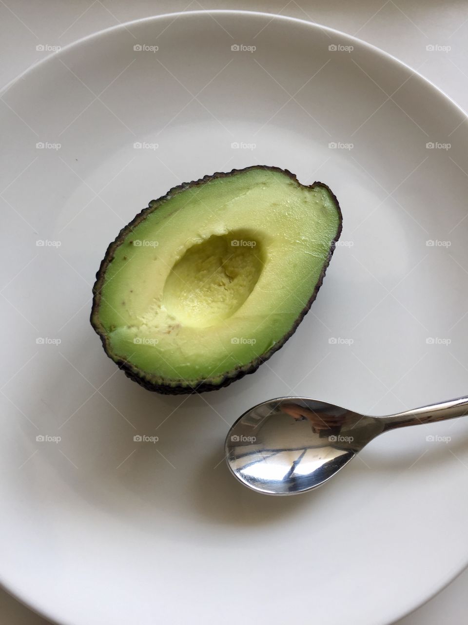 Half avocado w/ spoon