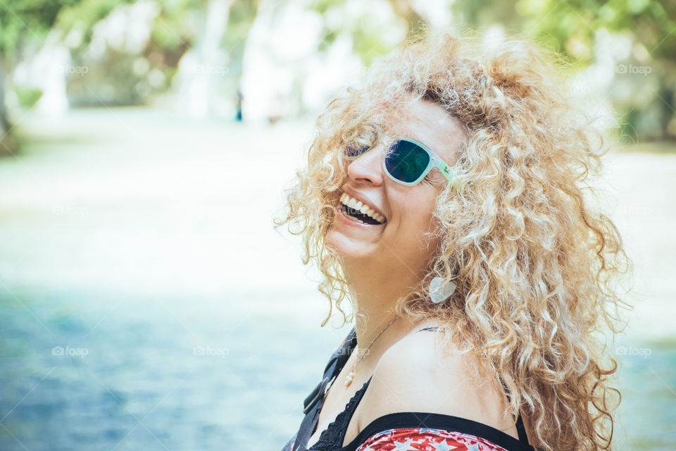 Laughing Happy Blonde Woman With Sunglasses On Vacation
