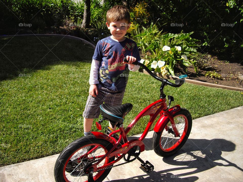 Young Boy With His Shiny New Bike
