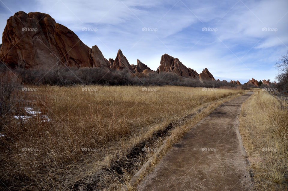 Footpath leading towards rocky mountain