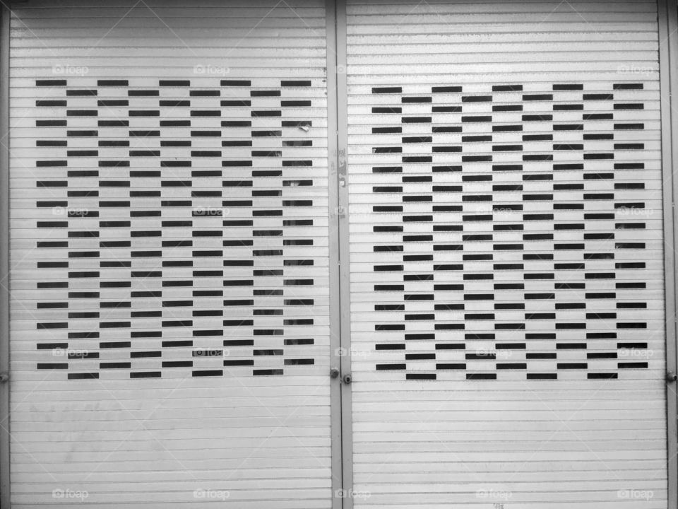Store shutters on Regent’s Park Road, Church End, London 