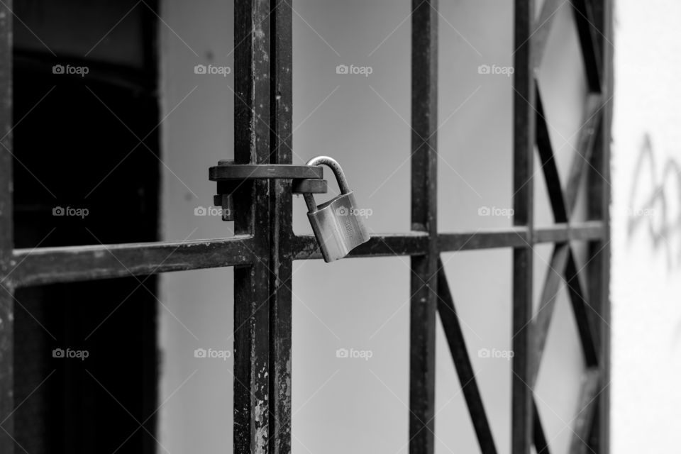 Padlock on a metal gate in city center