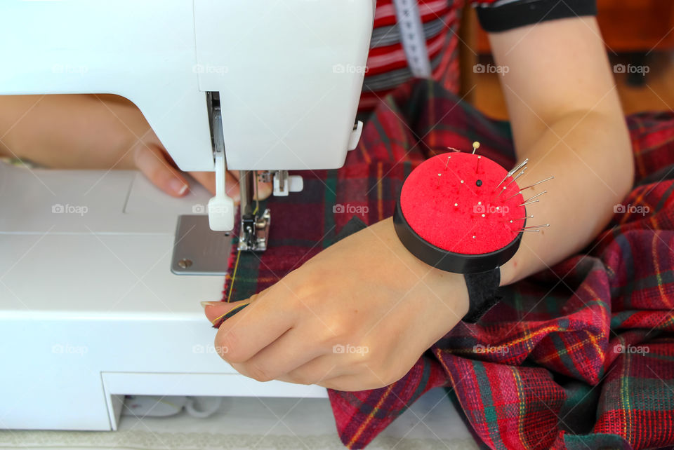 A needle pad around a seamstress arm