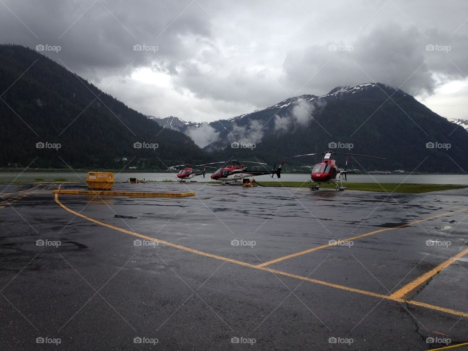 boarding helicopters in alaska to fly to the mountains for dog sledding