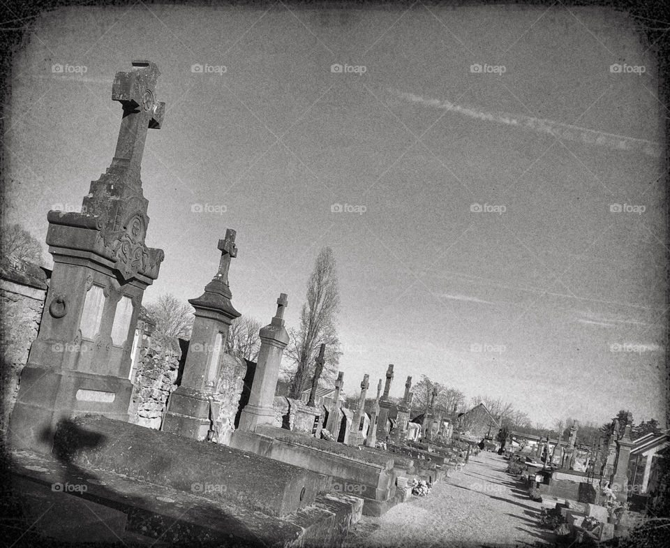 A black and white image of a row graves in a French cemetery 