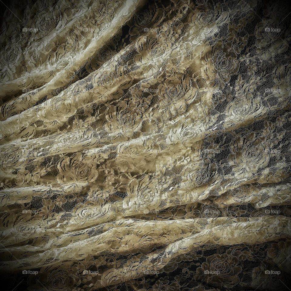 Vintage styled rose lace rippled fabric background with vignette