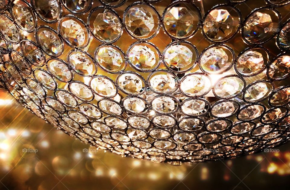 Sparkling crystal chandelier sending dazzling rainbows through the room.