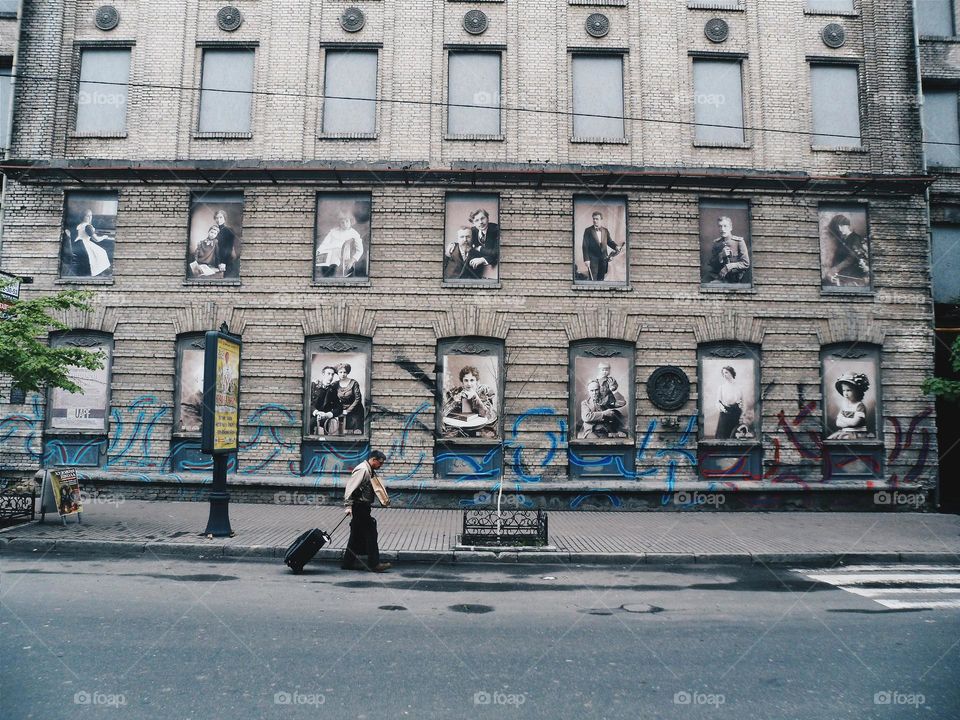 man with a suitcase on a city street