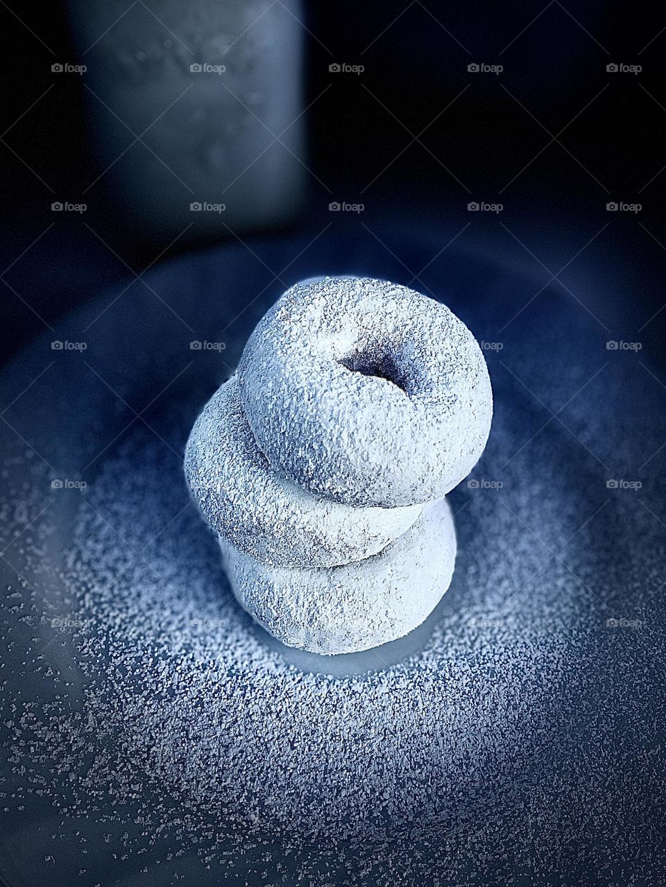 Three Stacked White Powdered Donuts