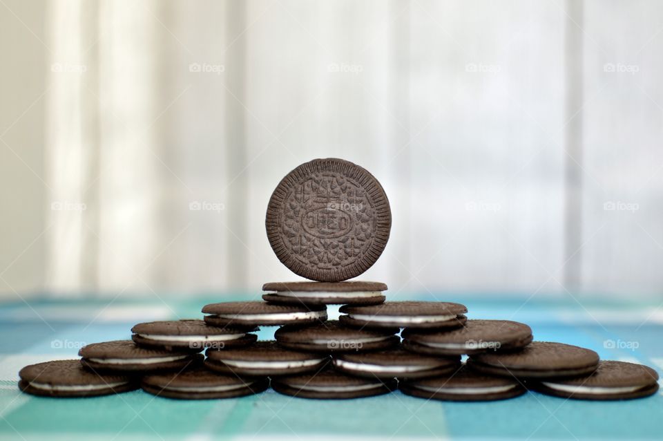 A pyramid of Oreo cookies on a white and blue background 