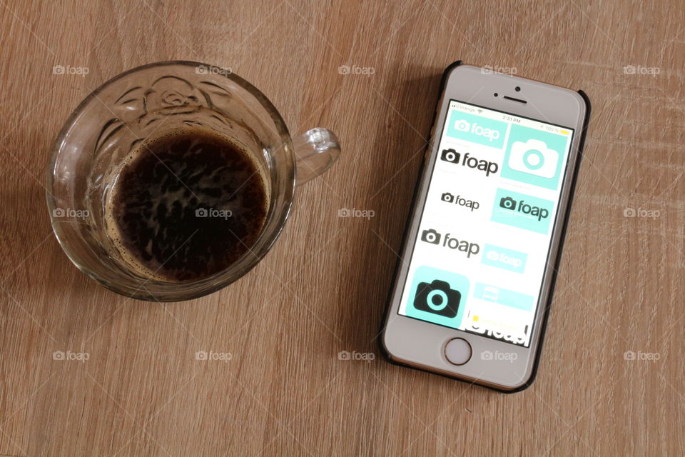 Foap searching on mobile and coffee cup 