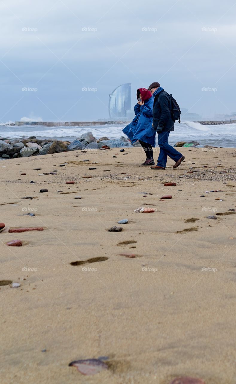 Elderly couple walking by the seaside 