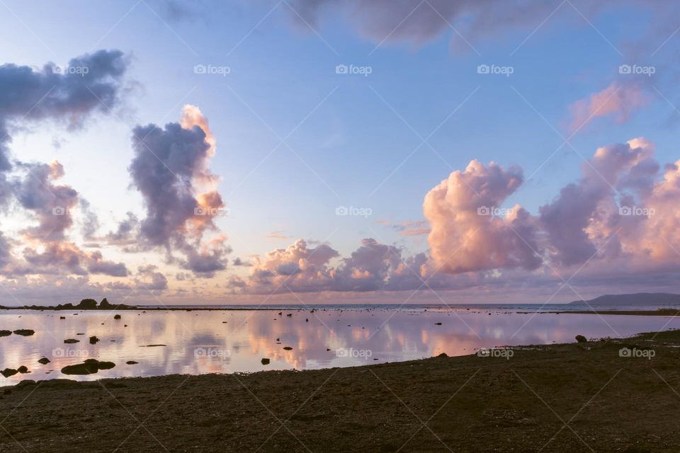 Beach landscape with clouds reflected on the sea