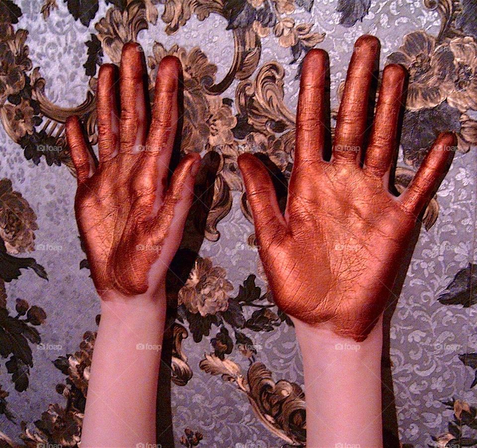 hands in gold paint