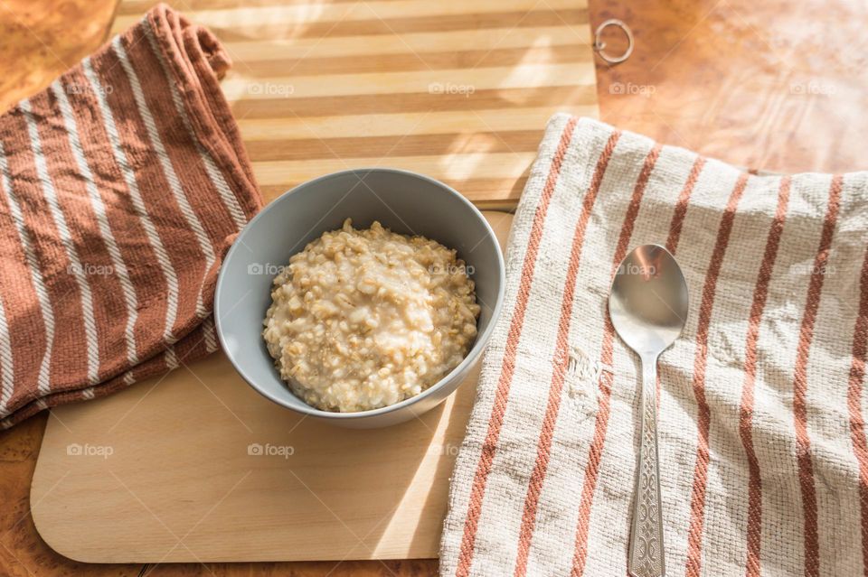 Cooked oatmeal in a deep gray plate.