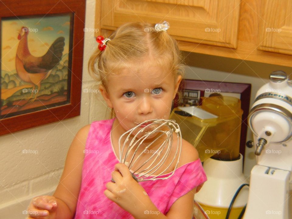 Girl licking the mixer