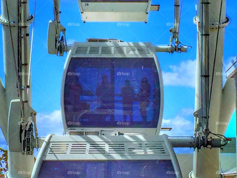Silhouettes of people on a Ferris wheel 