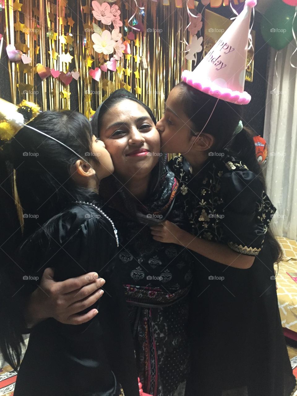 Mum and two cute daughter, lovely kiss 