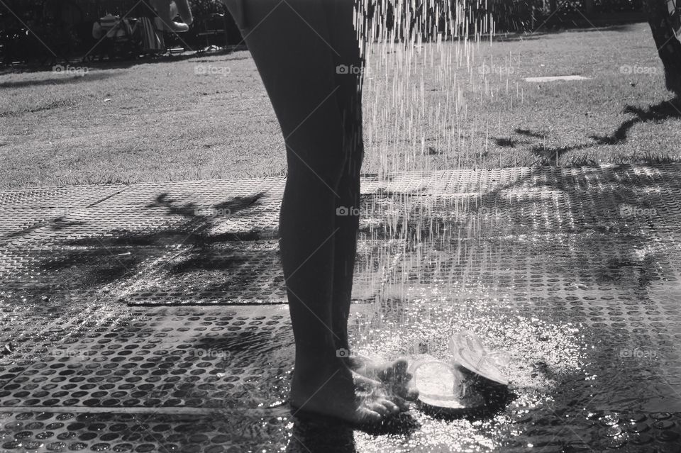 child refreshing herself on a summer day