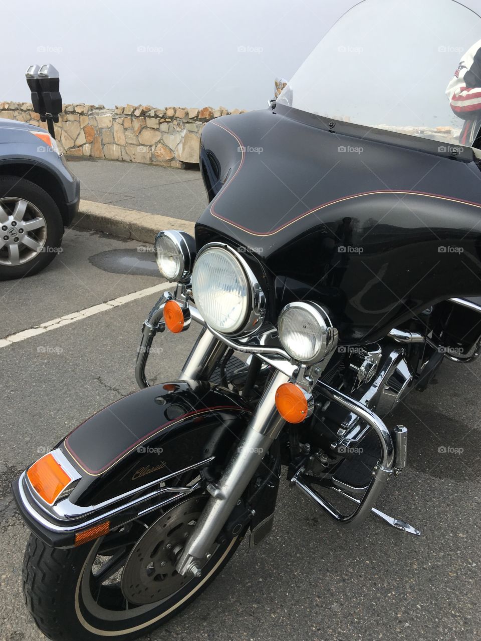 Harley Davidson parked near boardwalk in tourist area of The Pilgrims landing area in Plymouth, MA🇺🇸
