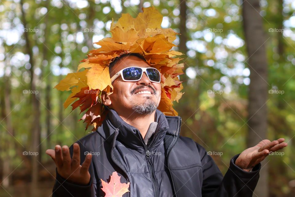 Smiling man in a crown of autumn leaves