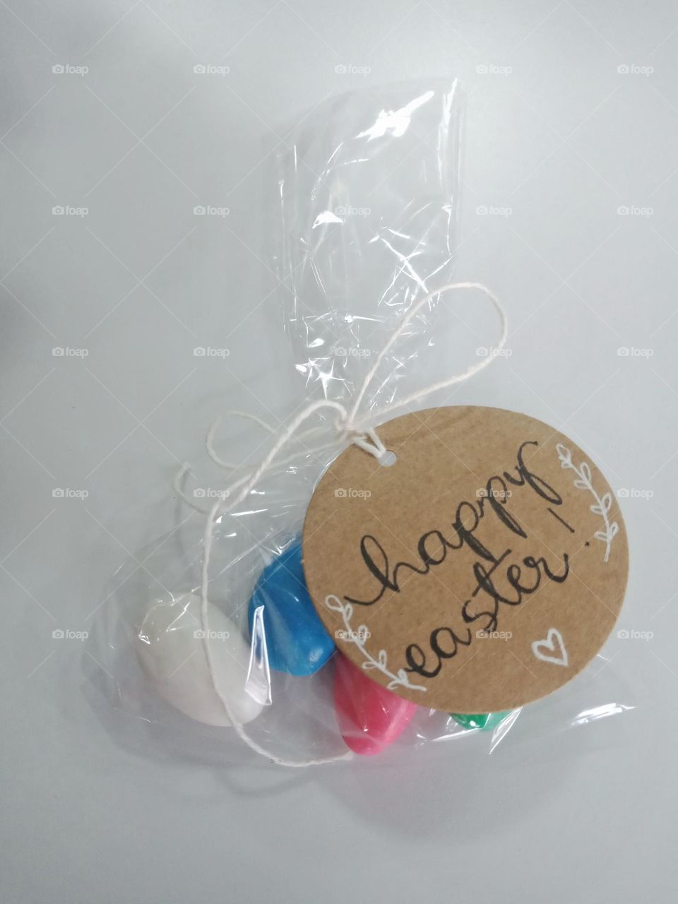 Sweet almonds for Easter. Handwritten tag card, on clear paper wrapping