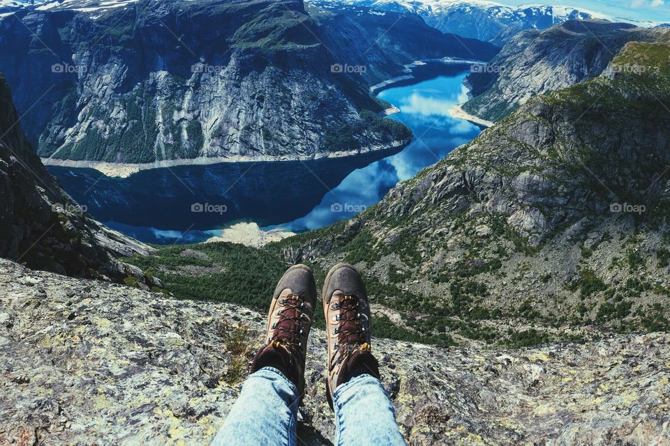 Feet view on Trolltunga rock above Geirenfiord in Norway