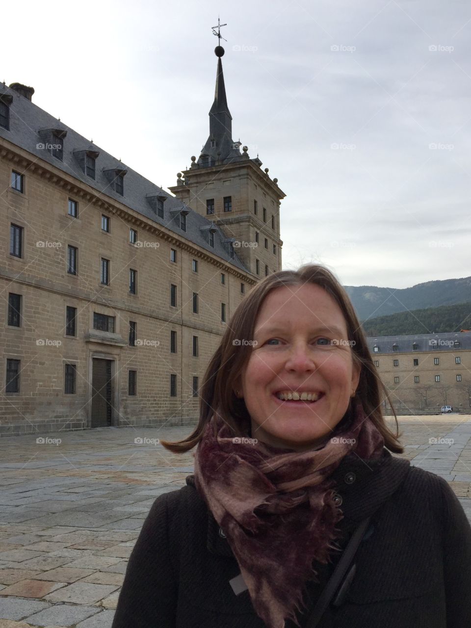 Portrait of smiling woman in front of El Escorial