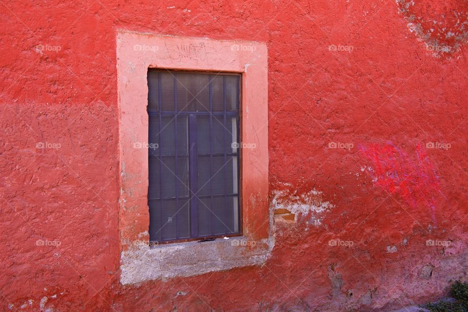 Window on red wall