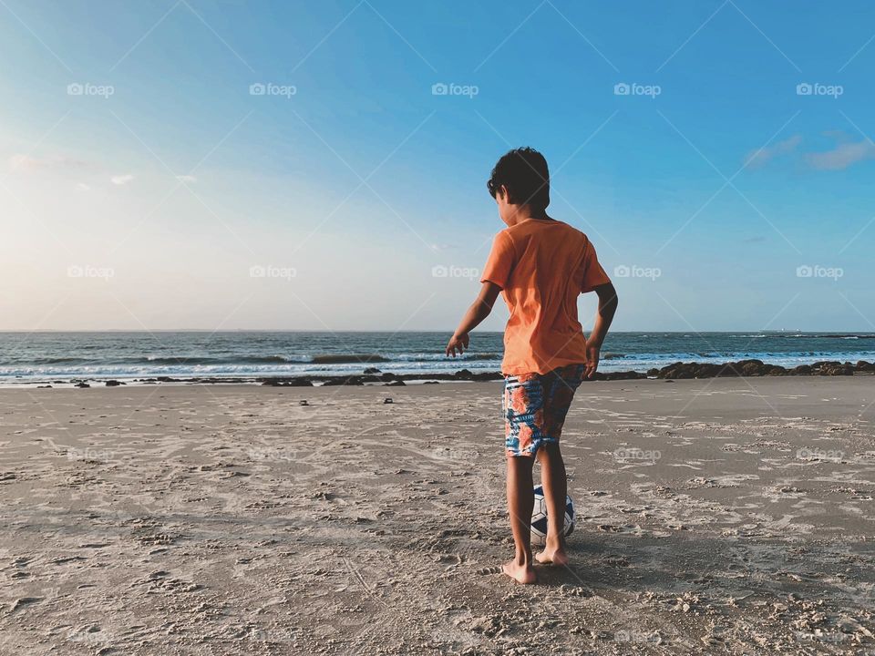 A boy playing at the beach