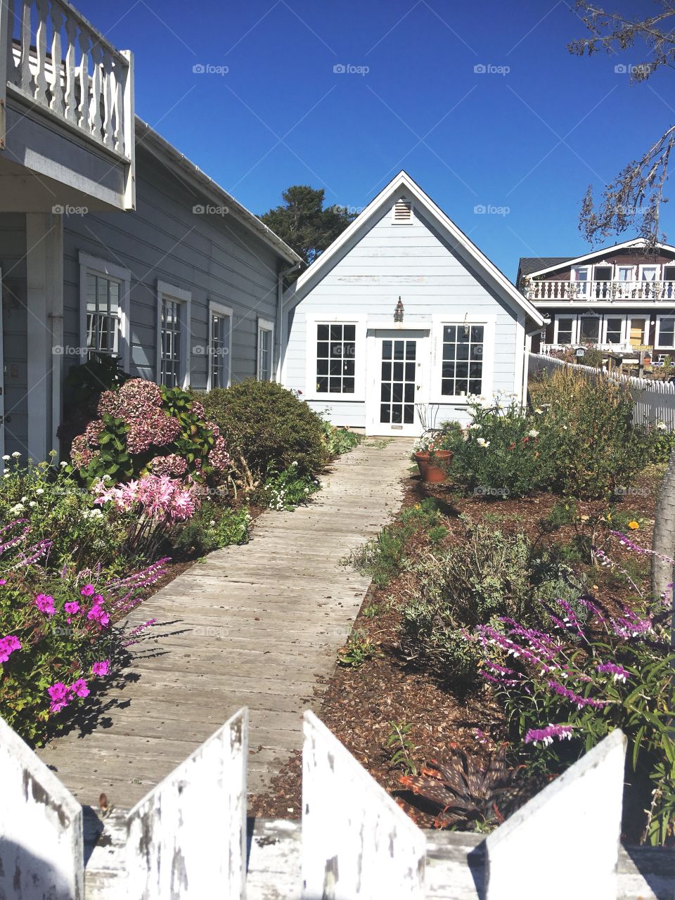 Cute beach cottage with white picket fence 