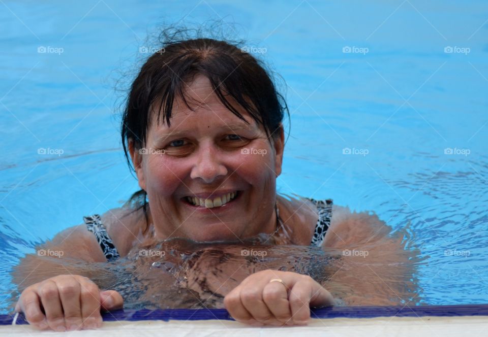 Mature woman smiling in swimming pool