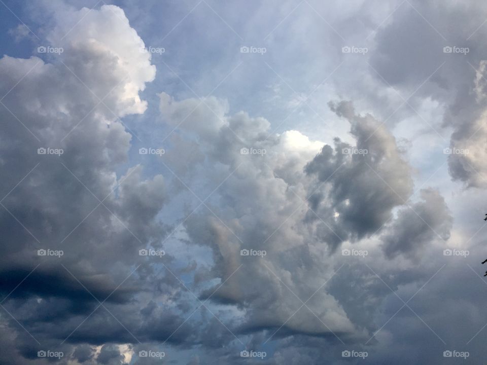 Towering clouds with dark undersides looming overhead before a rain storm