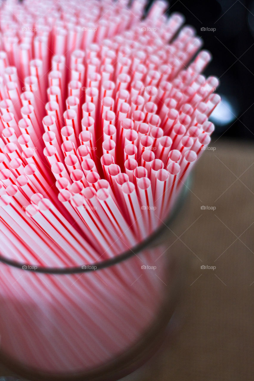 Glass jar of red and white straws