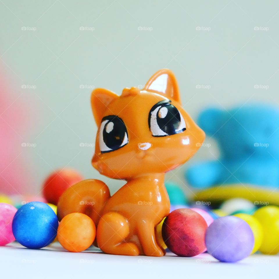 colored round balls with toys as backgrounds