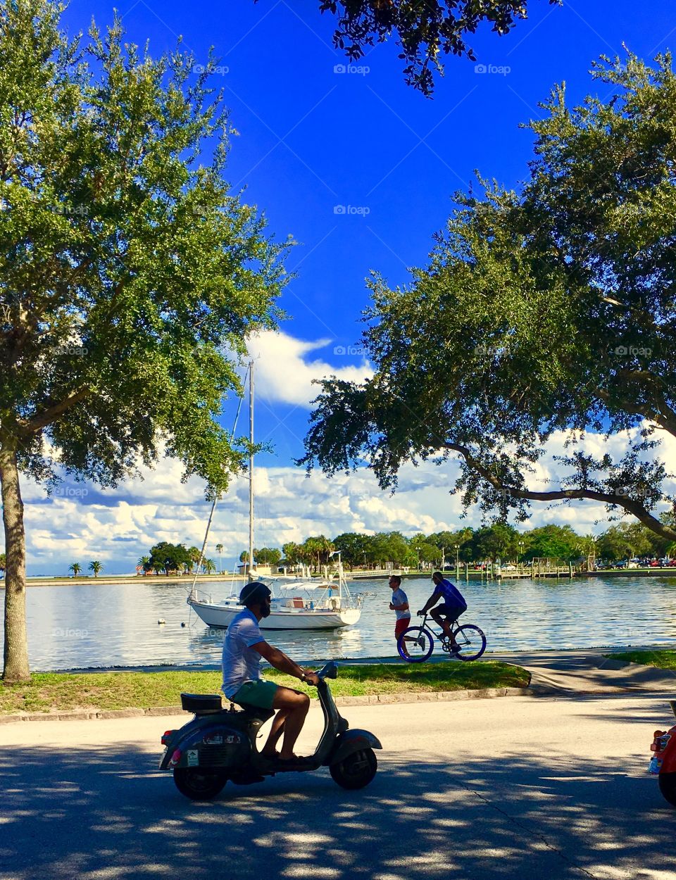 Vespa rider, jogger and Bicycler enjoying the day in St Petersburg FL