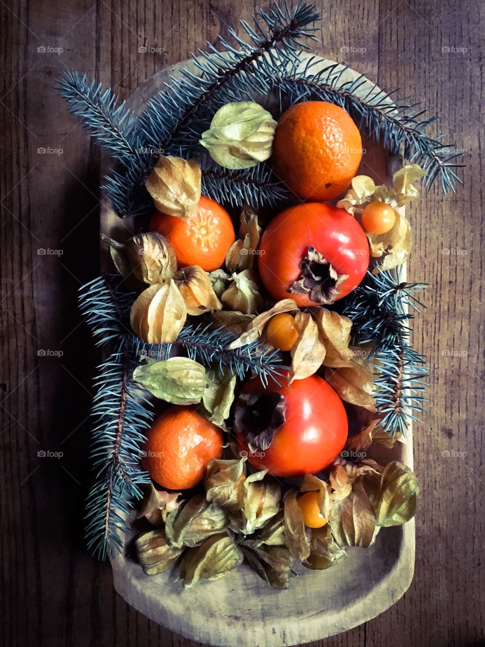 Winter fruit gathered in a wooden plate/bowl
