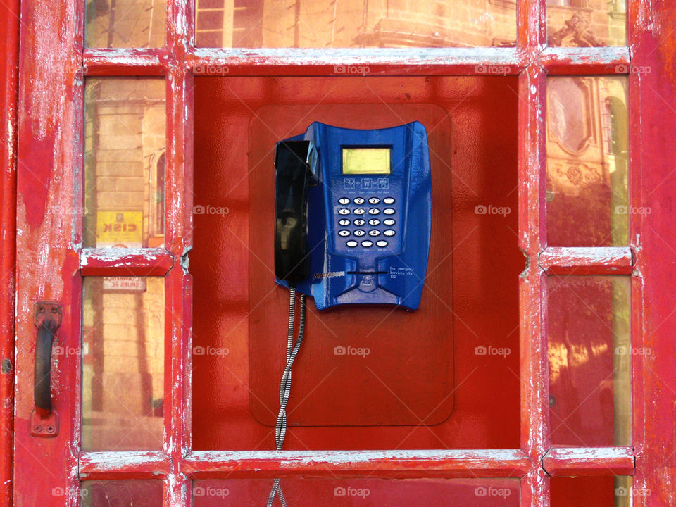 telephone box with broken glass