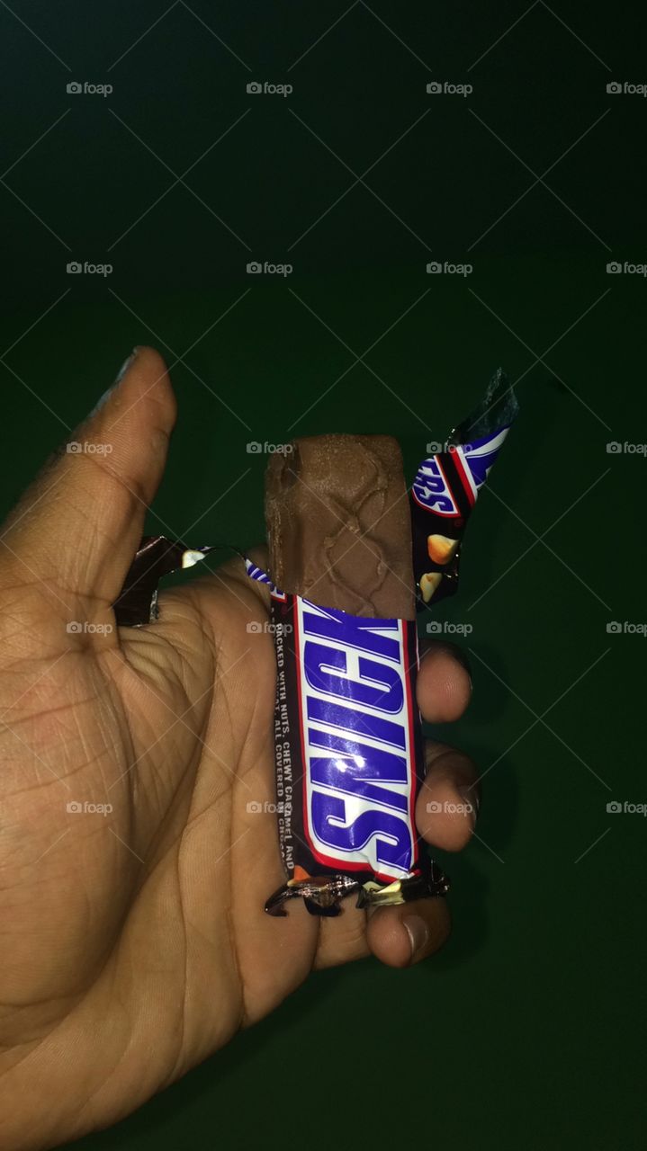 Chocolate Snickers in hand & is very tasty