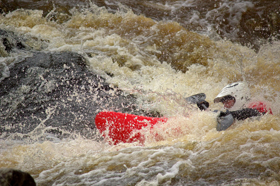 Helsinki, Finland - April 17, 2016: Unidentified racer at the annual iceBREAK whitewater kayaking competition at the Vanhankaupunginkoski rapids in Helsinki, Finland.