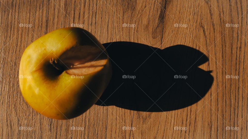 Apple shadow on wood texture