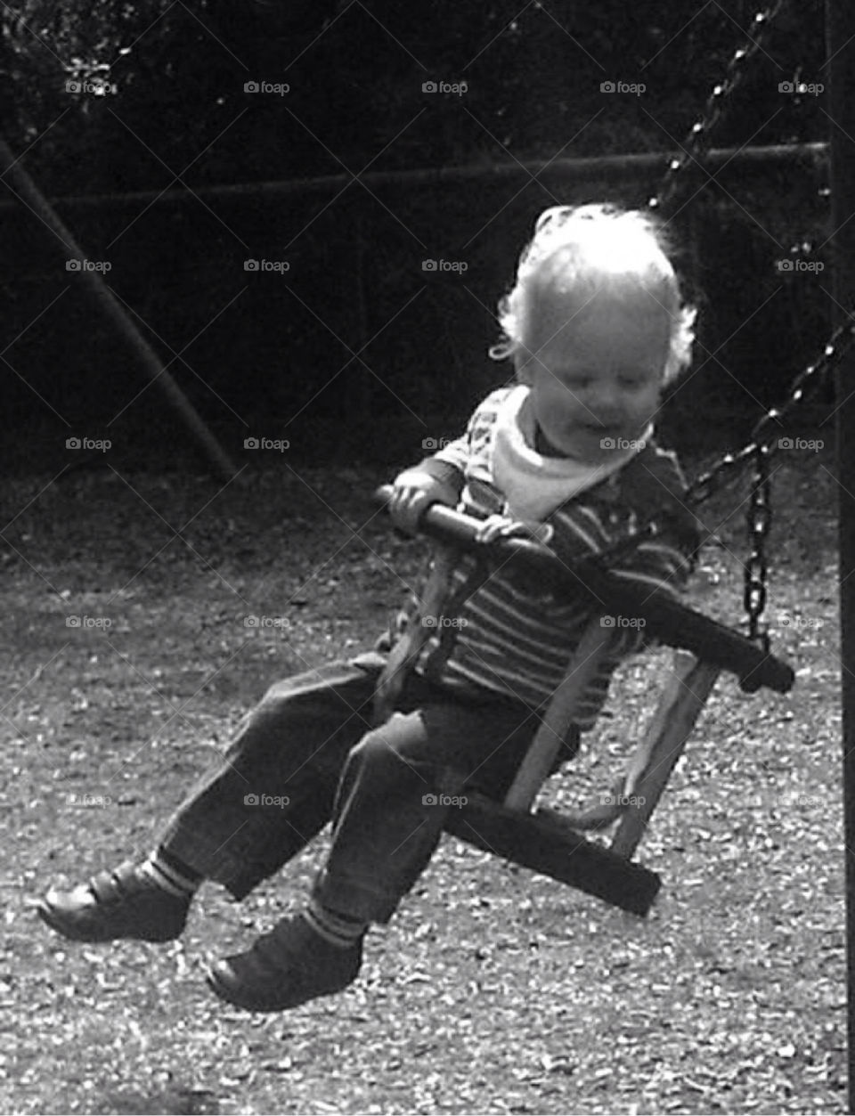 Happy toddler on swing