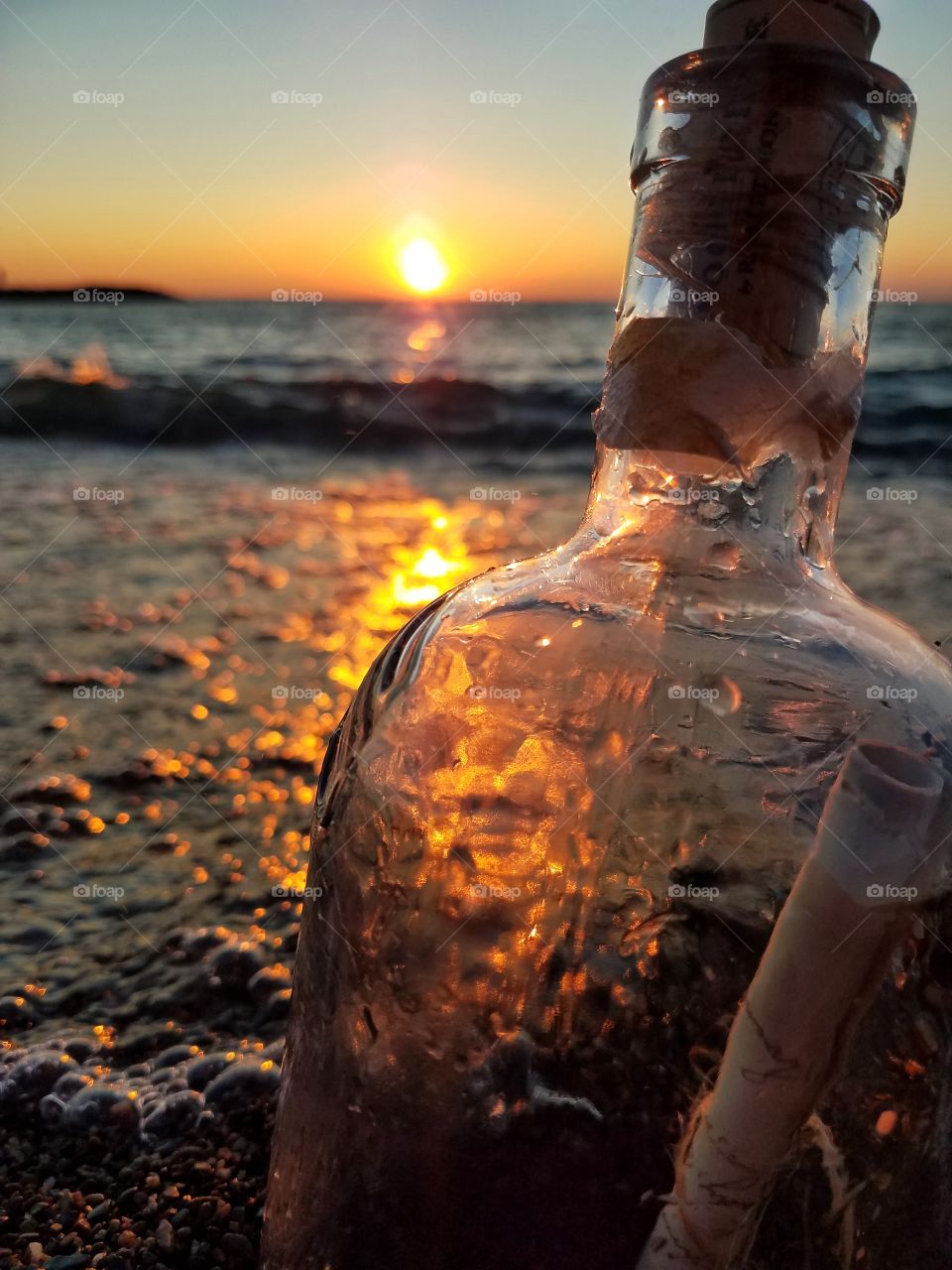 Message in a bottle. Beach at sunset