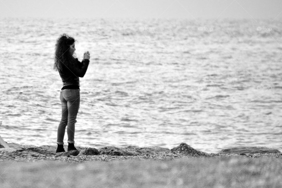 a girl takes a picture on the seaside