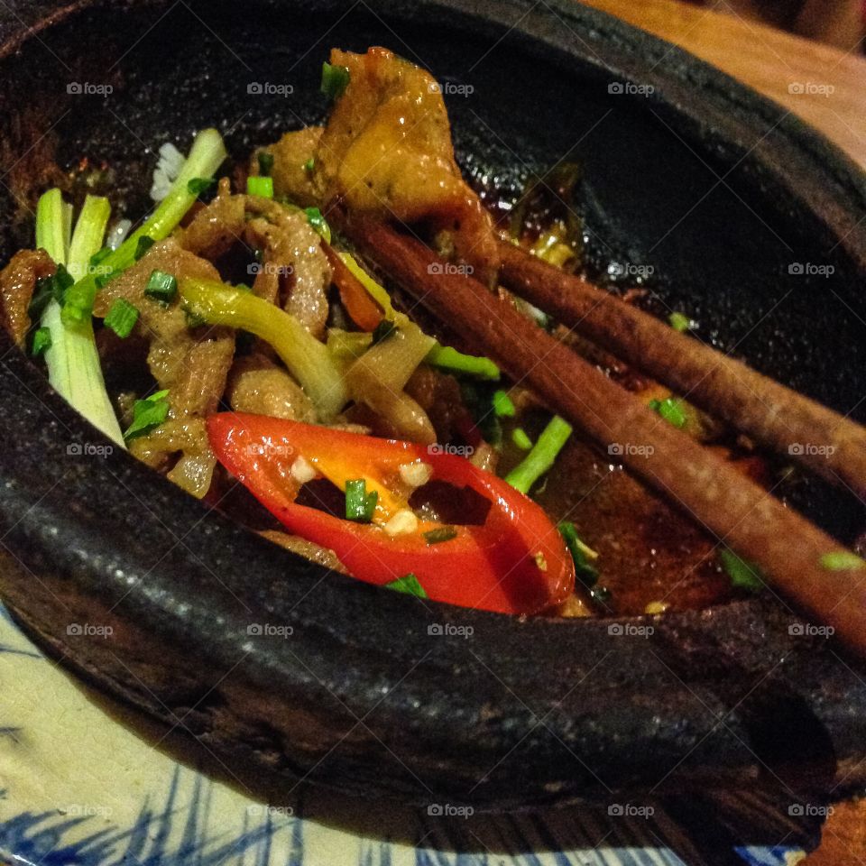 Caramelize beef in hot vietnamese pot.