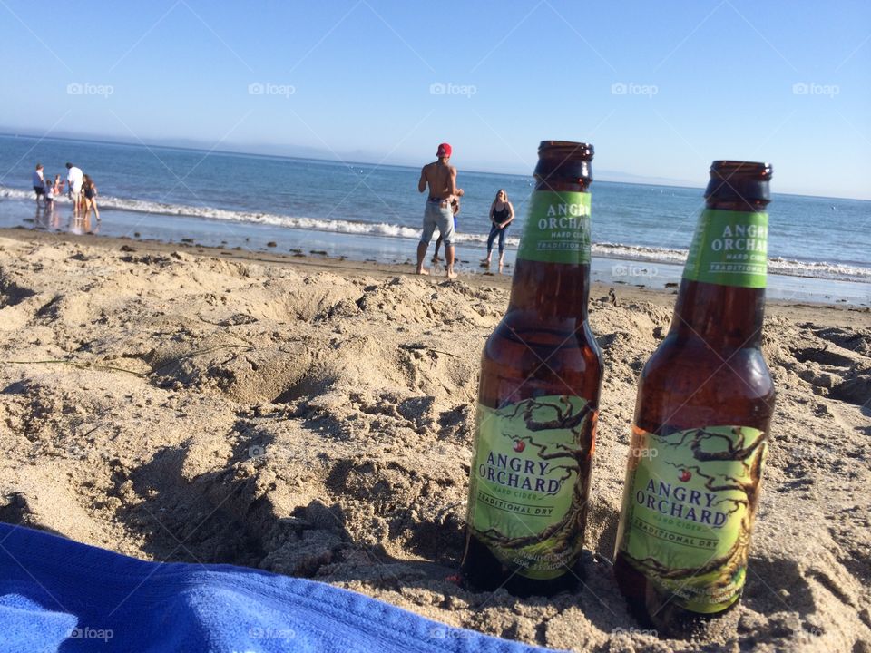 Have an angry orchard or two before playing in the waves of the ocean. 