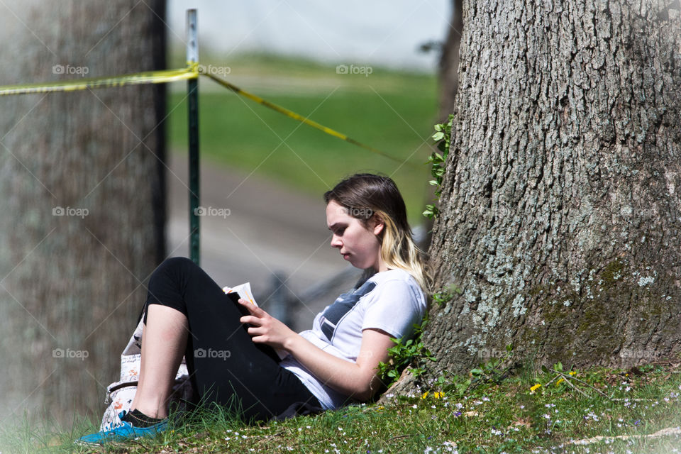 nothing can beat reading your favorite book in a park, with the tree trunk as your back rest and grass your chair.