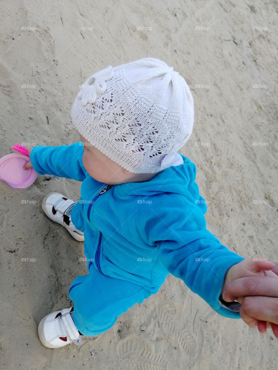 Baby is walking, hold the hand