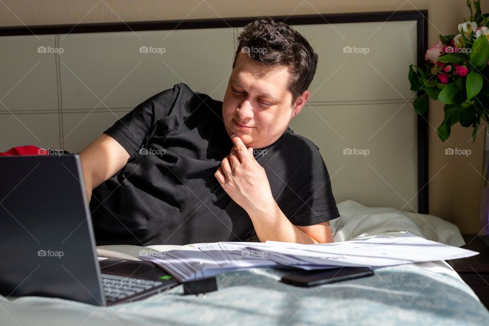 man resting at home with documents