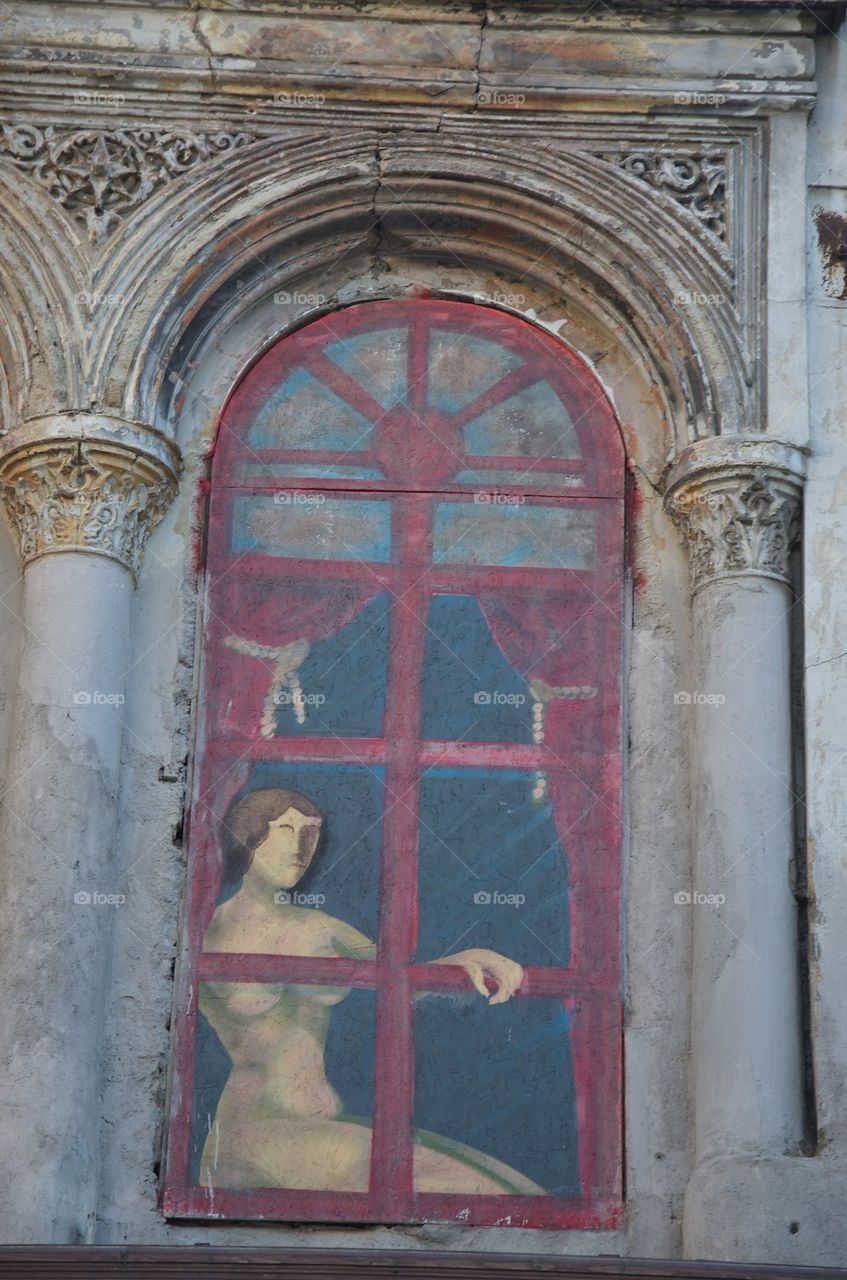 Feminine figure behind the window, Lipscani, Bucharest